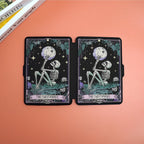 Two tarot cards titled 'The Overthemer' on a peach-colored surface with a book partially visible.